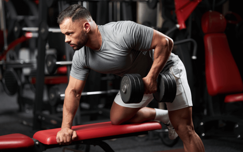 Image of a bodybuilder doing a dumbbell row.