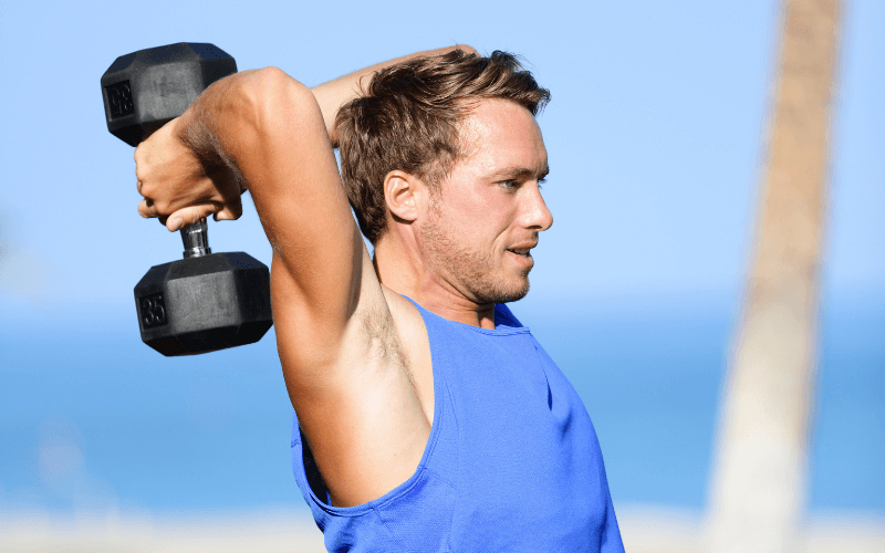 Image of a bodybuilder doing an overhead tricep extension.