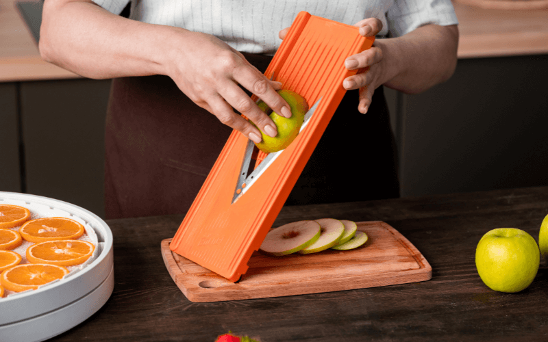 Image of a person with a mandoline slicer