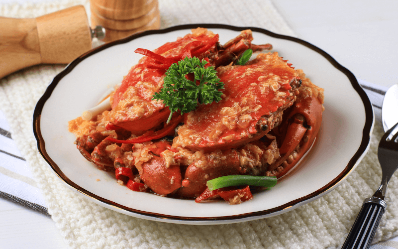 Image of a platter of Chilli Crab with some side dishes