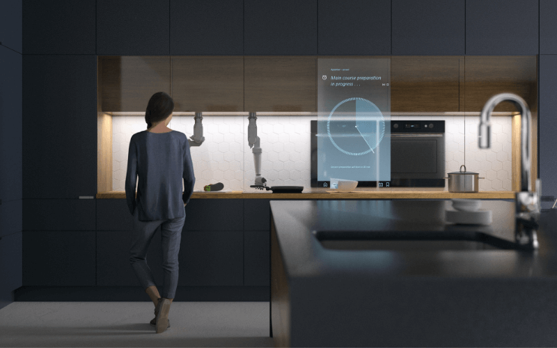 Image wide shot of a kitchen, every piece of furniture and appliance is black in colour, with blue holograms floating in front of certain appliances, the fridge, oven, stove, etc.
