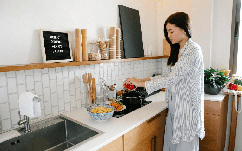 6 Kitchen Appliances You’re Going To Need To Become A Master Chef Image of a person cooking.