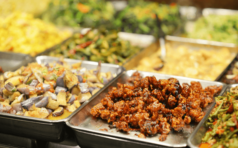 Assortment of dishes served in stainless steel trays