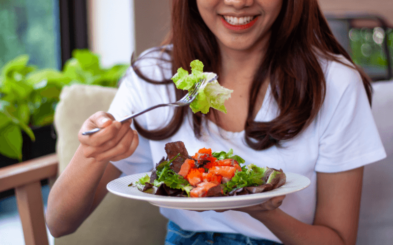 Meat-Free Marvels: 8 Vegetarian Dishes And Restaurants In Singapore Image of a person eating vegetarian dishes