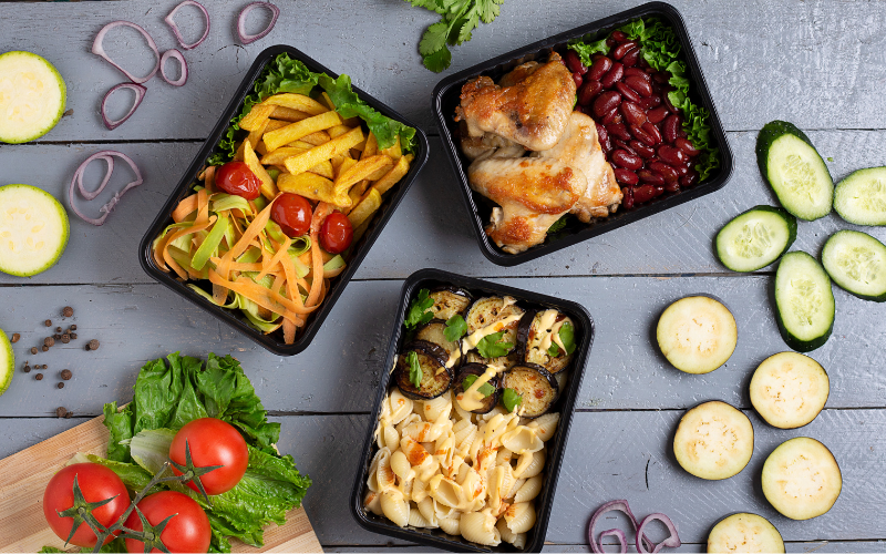 Image of 3 different packaged meals on a table