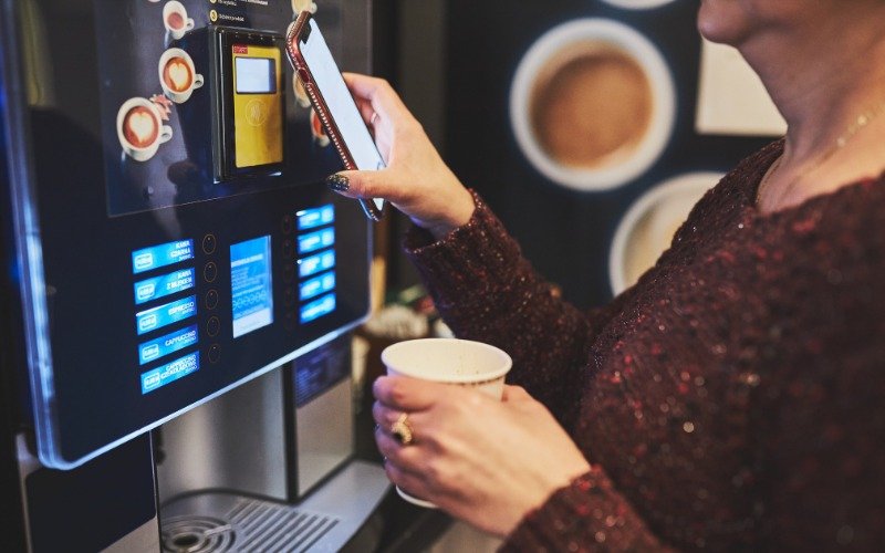 Image of a person looking at a coffee machine.