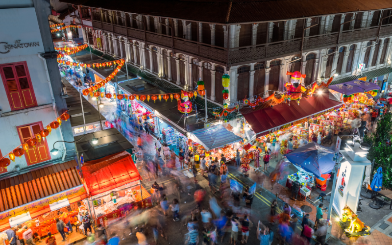 A Guide To The Perfect Night Out In Singapore: Cafés, Clubs & Comedy Image of the nightlife scene in Singapore, with bright lights and crowded streets