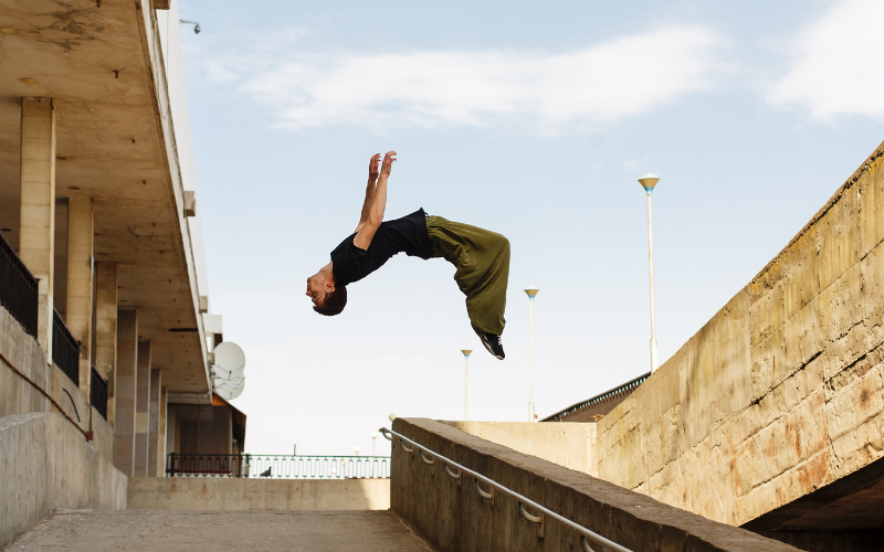How Parkour Strength Training Can Improve Your Overall Sports Performance Person jumping from a building to another
