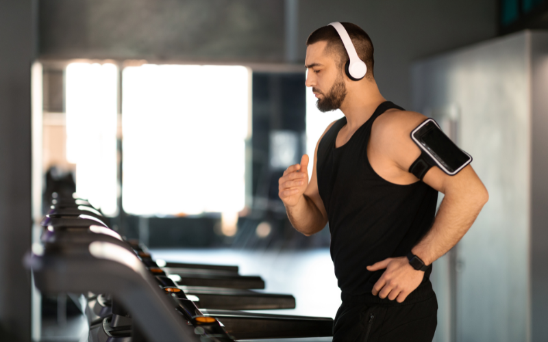 Image of a person wearing wireless headphones while working out