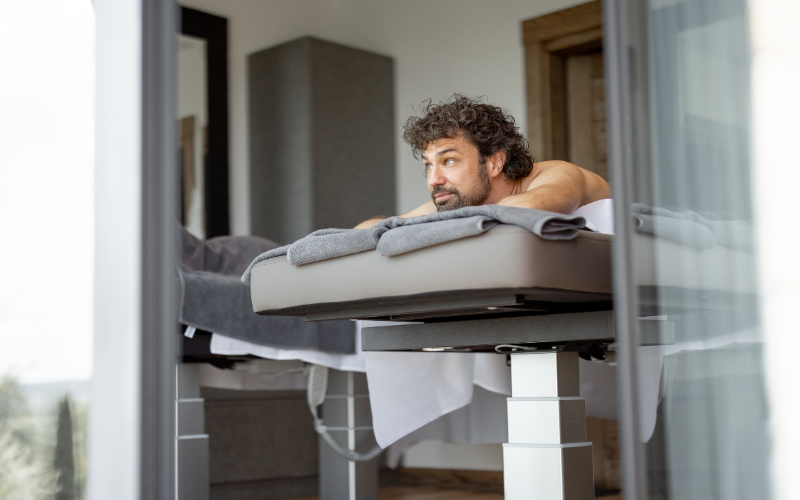 Image of an athlete waiting on a massage bed