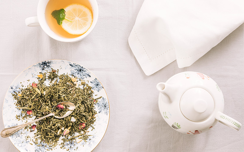 A tea setup with herbal blends placed on a clean table.