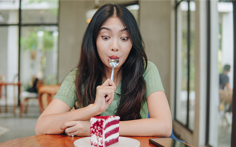 A person eating a slice of cake.