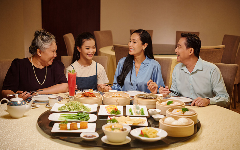 A stock photo of a family enjoying healthy food together at a restaurant.