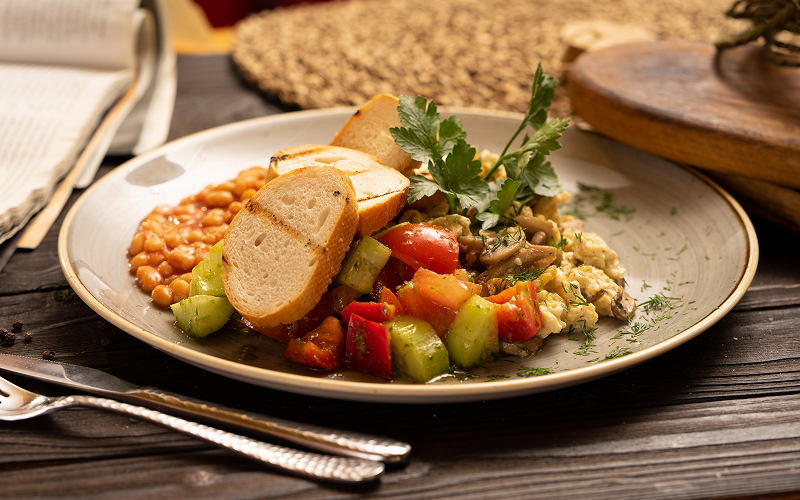 A plate of proteins with vegetables and whole grains served at a casual open-air restaurant