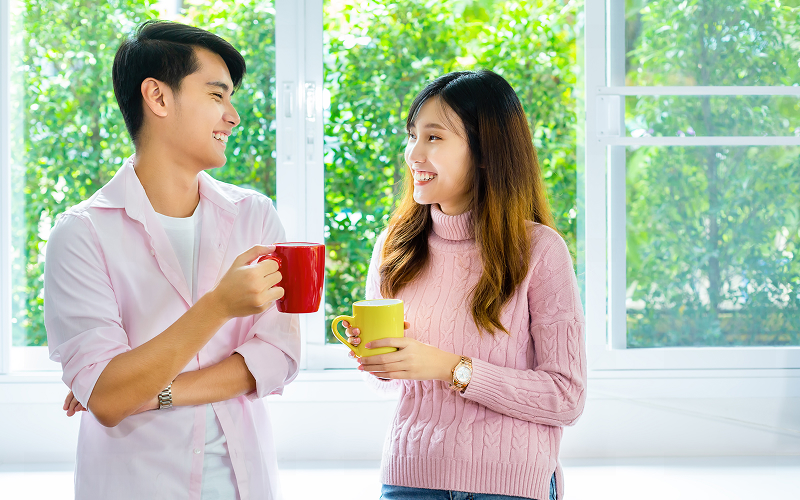 People sharing a conversation with a cup of tea.