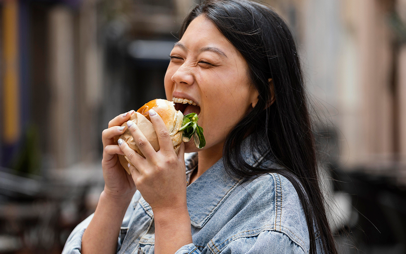 Lifestyle or candid image showing someone enjoying the burger.