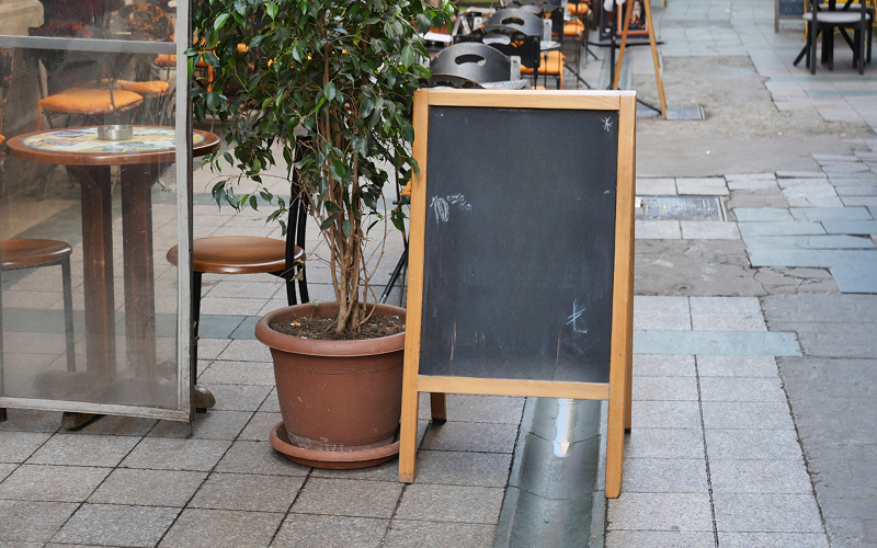 A menu stand outside a restaurant