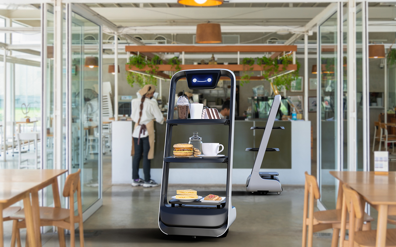 A stock photo of a robot server delivering food.