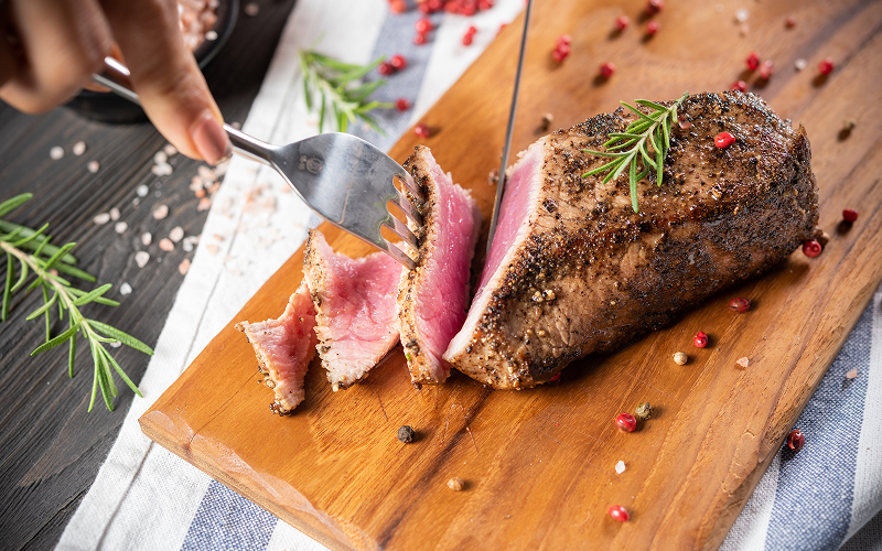 Image of a medium rare cut of cooked steak