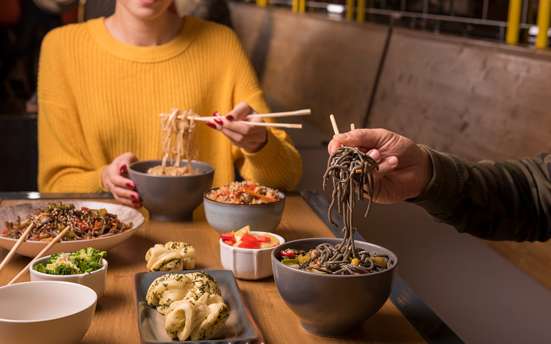 Image of a group eating noodles.