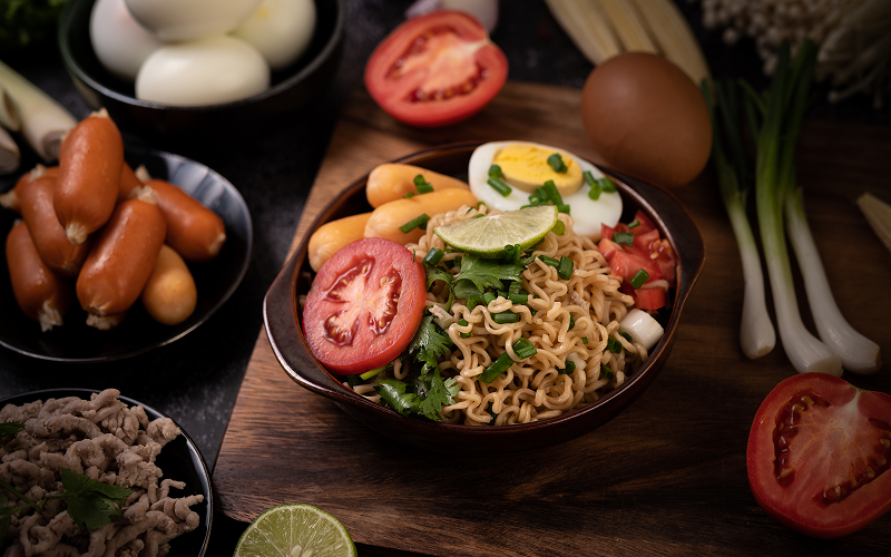 Image of a noodle bowl with plenty of toppings and sides.