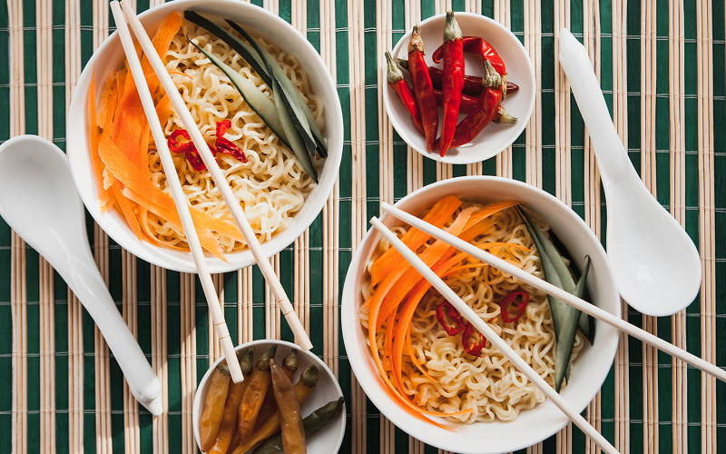 Image of a table filled with noodle bowls.