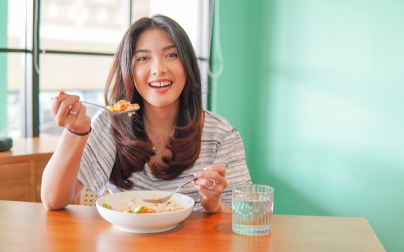 a person eating Malaysian food