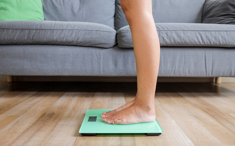 A woman on a weighing scale