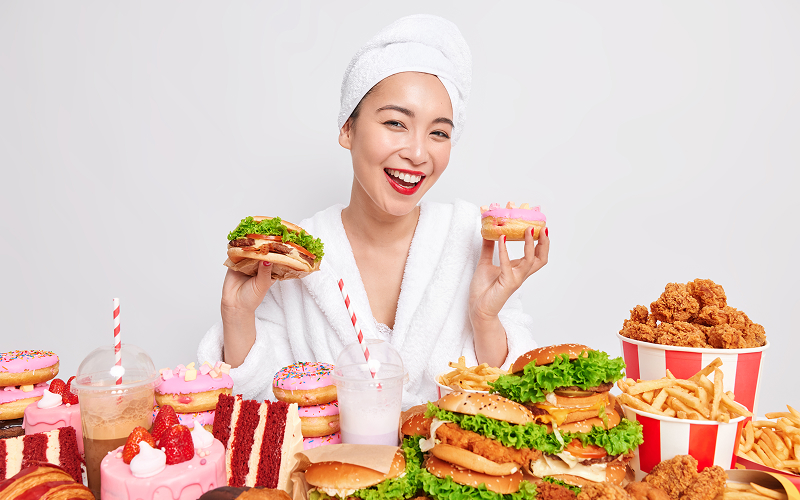 Image of a fit person eating a lot of food