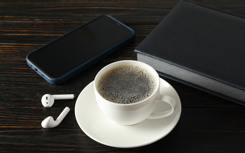 a smartphone and a coffee on a table