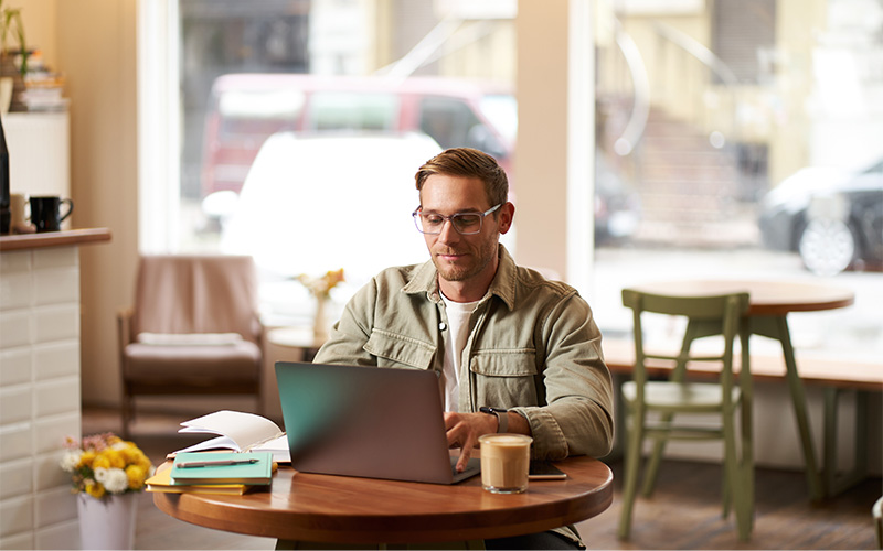 4 Interesting Cafes in Singapore That Are Perfect for Digital Nomads A digital nomad in a cafe